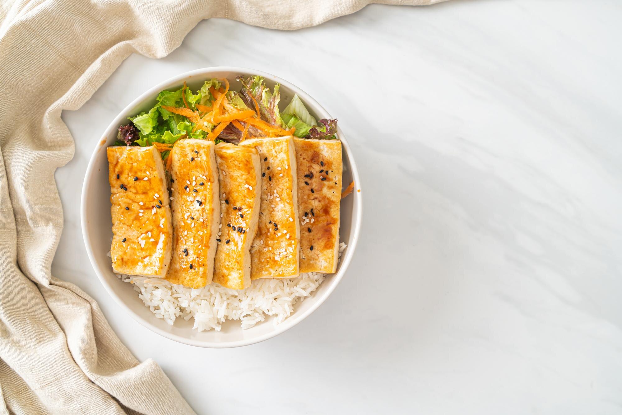 A bowl of rice with firm tofu and vegetables — an example of a simple low-FODMAP Phase 1 meal with plain rice, protein, and well-tolerated ingredients