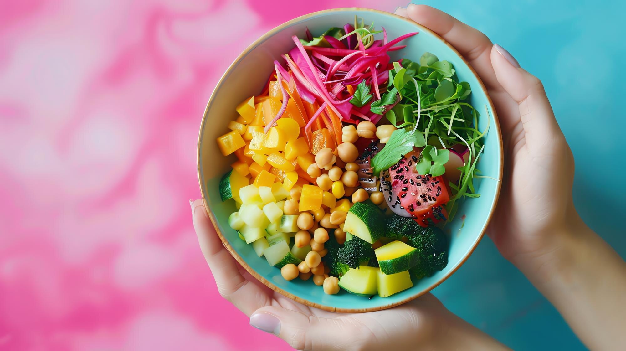 A vibrant salad bowl containing chickpeas, mixed vegetables and microgreens, representing a personalised whole-food meal